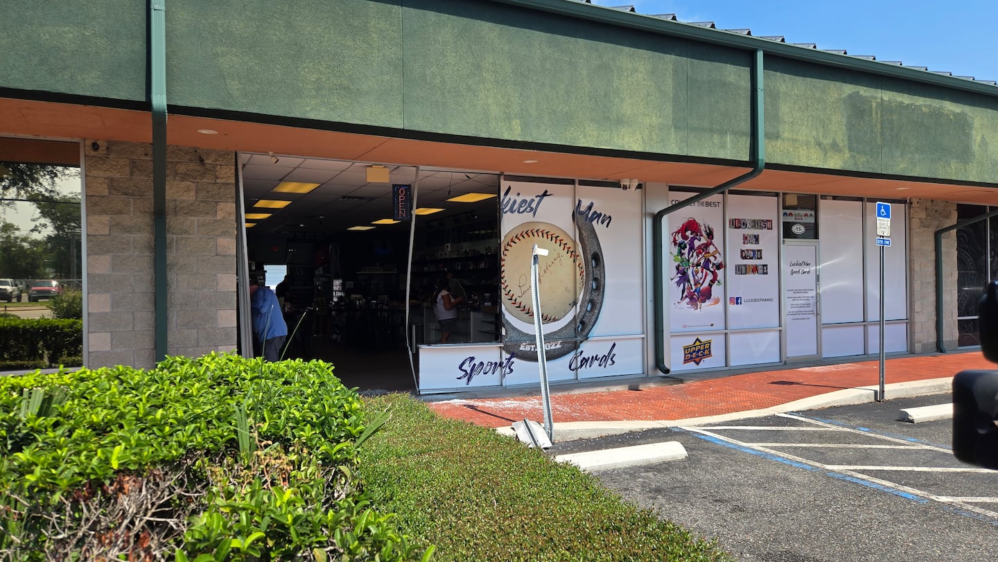 Luckiest Man Sportscards storefront wide open after car crashes into it