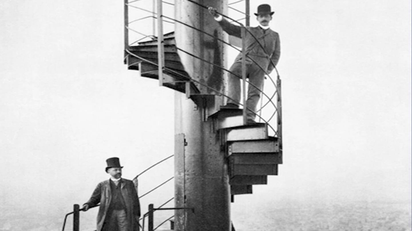 Gustave Eiffel, left, and a friend stand on the spiral staircase of the Eiffel Tower in 1889.