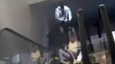 WATCH: Man drags woman down escalator during purse snatching at mall