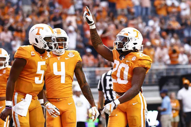 Tennessee running back Jaylen Wright (20) reacts to scoring a touchdown with quarterback Hendon Hooker (5) and wide receiver Cedric Tillman (4) during the first half of an NCAA college football game against Akron, Saturday, Sept. 17, 2022, in Knoxville, Tenn.